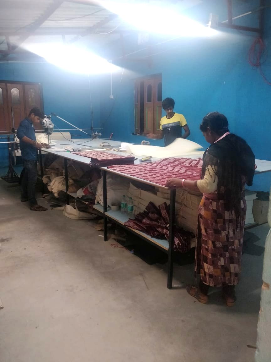 Fabric cutting facility at the Haastika factory with cutting tables and workers