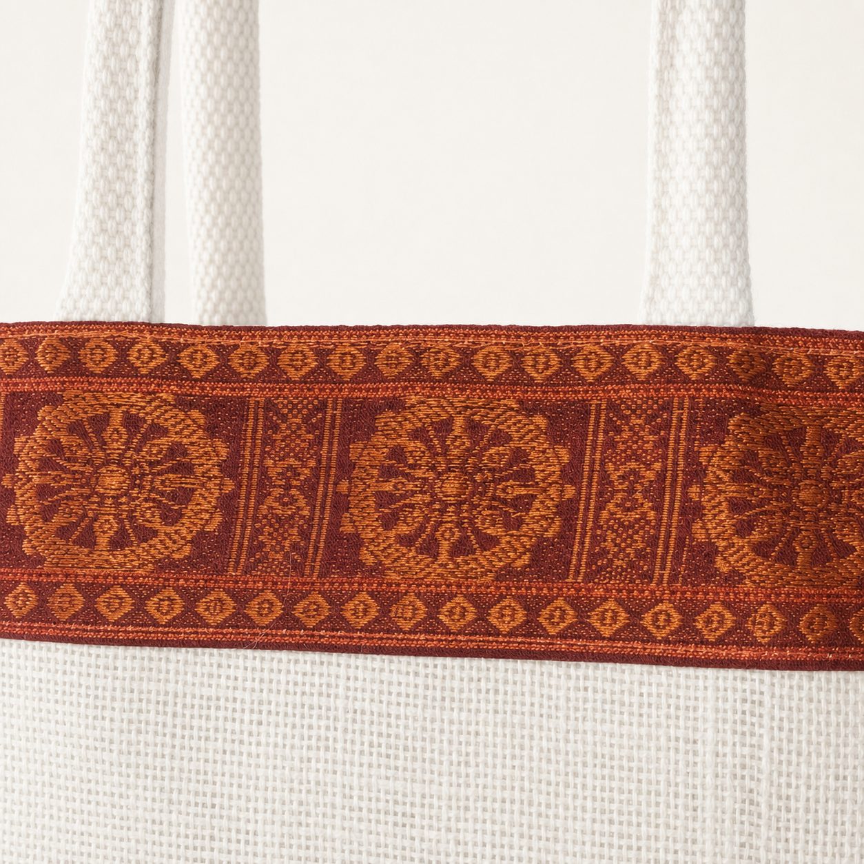 Close-up of the red Sambalpuri woven border with Konark wheel motifs